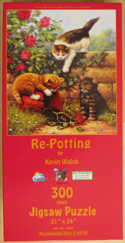 Three kittens playing in a garden with a tipped-over clay pot, by Kevin Walsh.