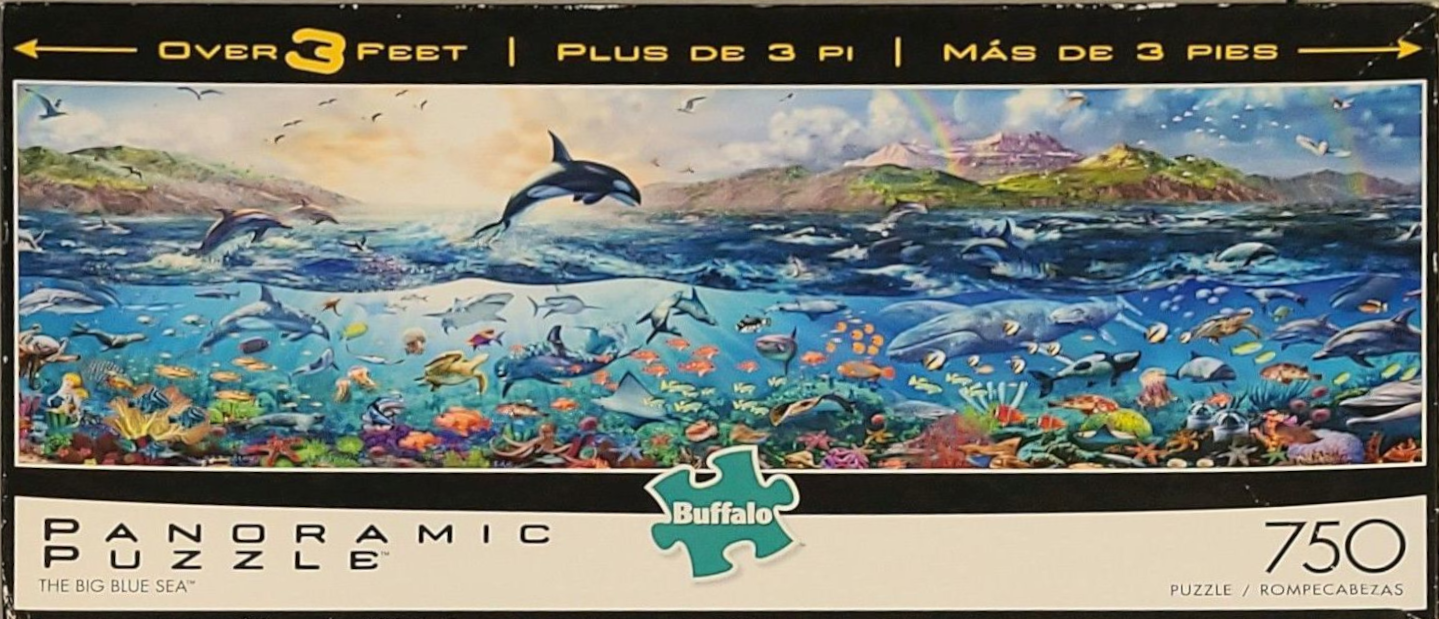 A panoramic underwater scene featuring dolphins, a whale, sea turtles, and coral reefs.