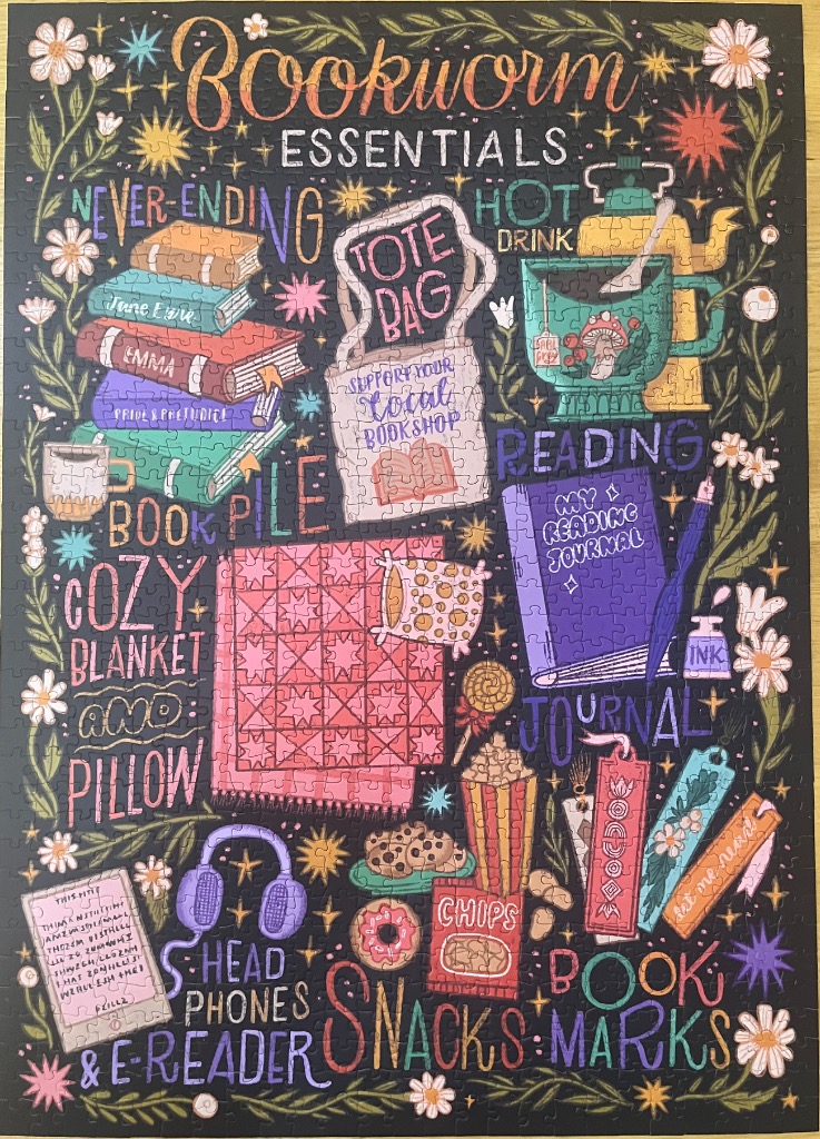 A whimsical illustration of reading essentials labeled with stylized hand-lettered text against a black background.