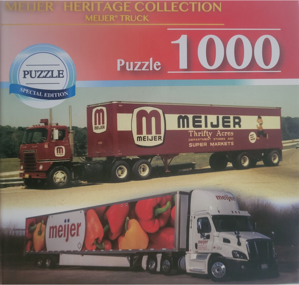 Two semi-trucks: an older maroon truck in the background and a modern white truck featuring red and yellow peppers.