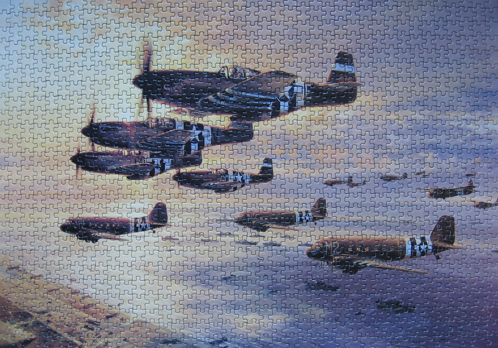 A military illustration of P-51 Mustang fighter planes escorting C-47 transport aircraft over a shoreline at sunset.