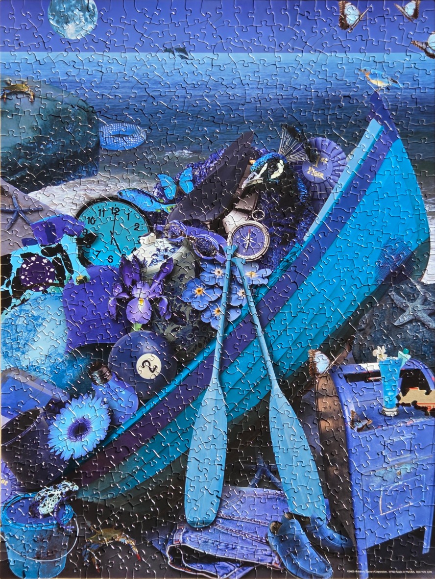 A whimsical collage of blue objects including a boat, flowers, a peacock, and a clock against a moonlit sea background.