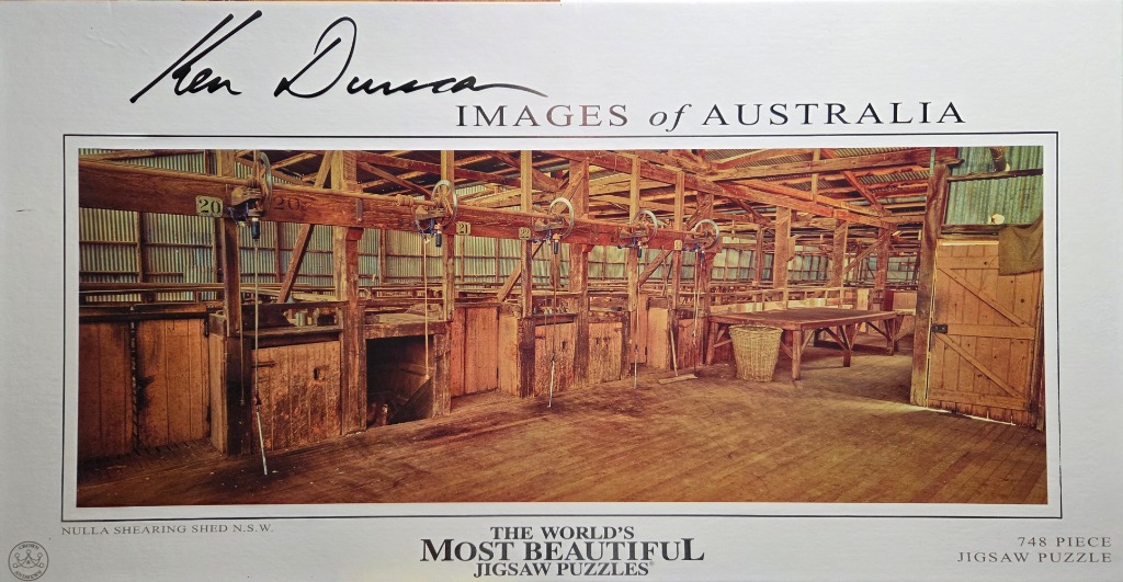 A photograph of the interior of an old wooden sheep shearing shed with numbered stations.