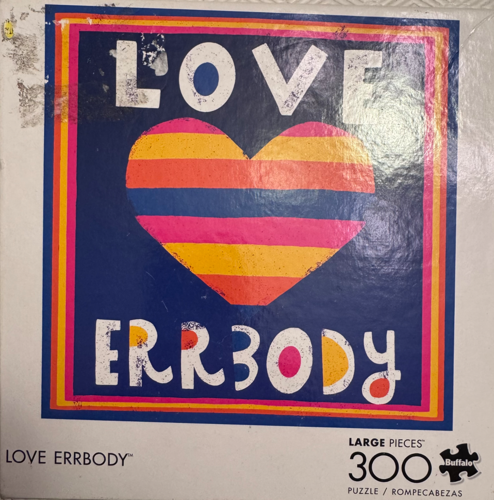 A graphic design featuring the text LOVE ERRBODY and a multi-colored striped heart against a blue background.