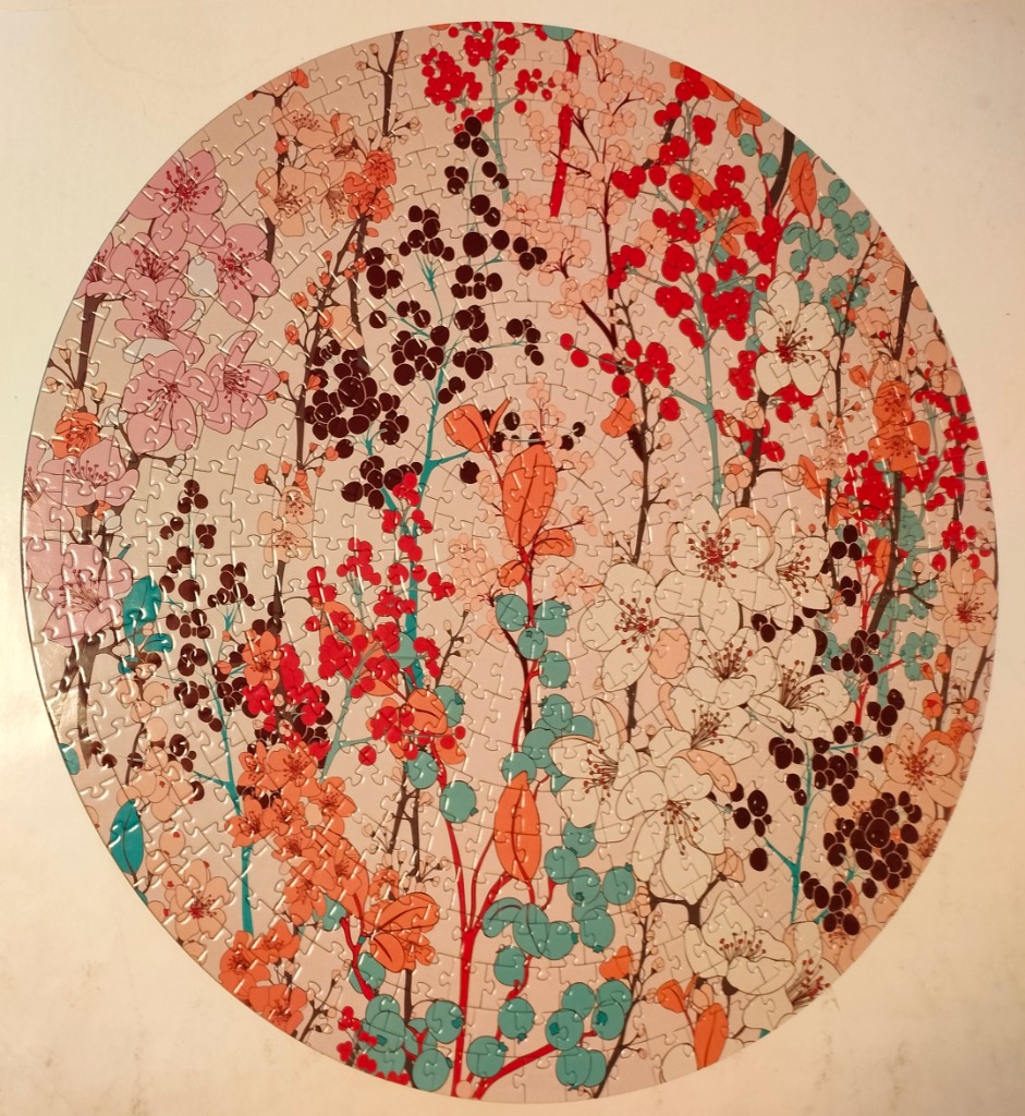 Circular art featuring a botanical pattern of cherry blossoms, berries, and foliage on a soft, light pink background.