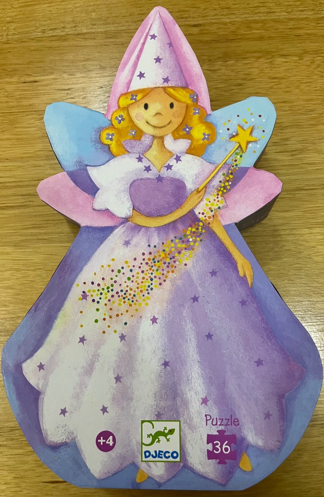 Illustration of a smiling fairy in a lavender dress and pointed hat, holding a star-tipped magic wand.