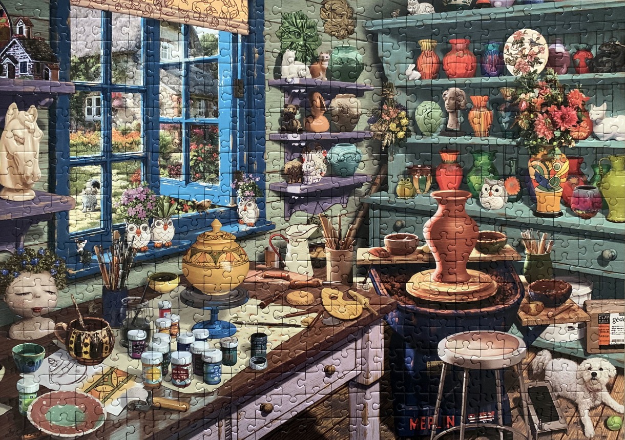 A detailed illustration of a cozy, cluttered pottery studio overlooking a cottage garden.