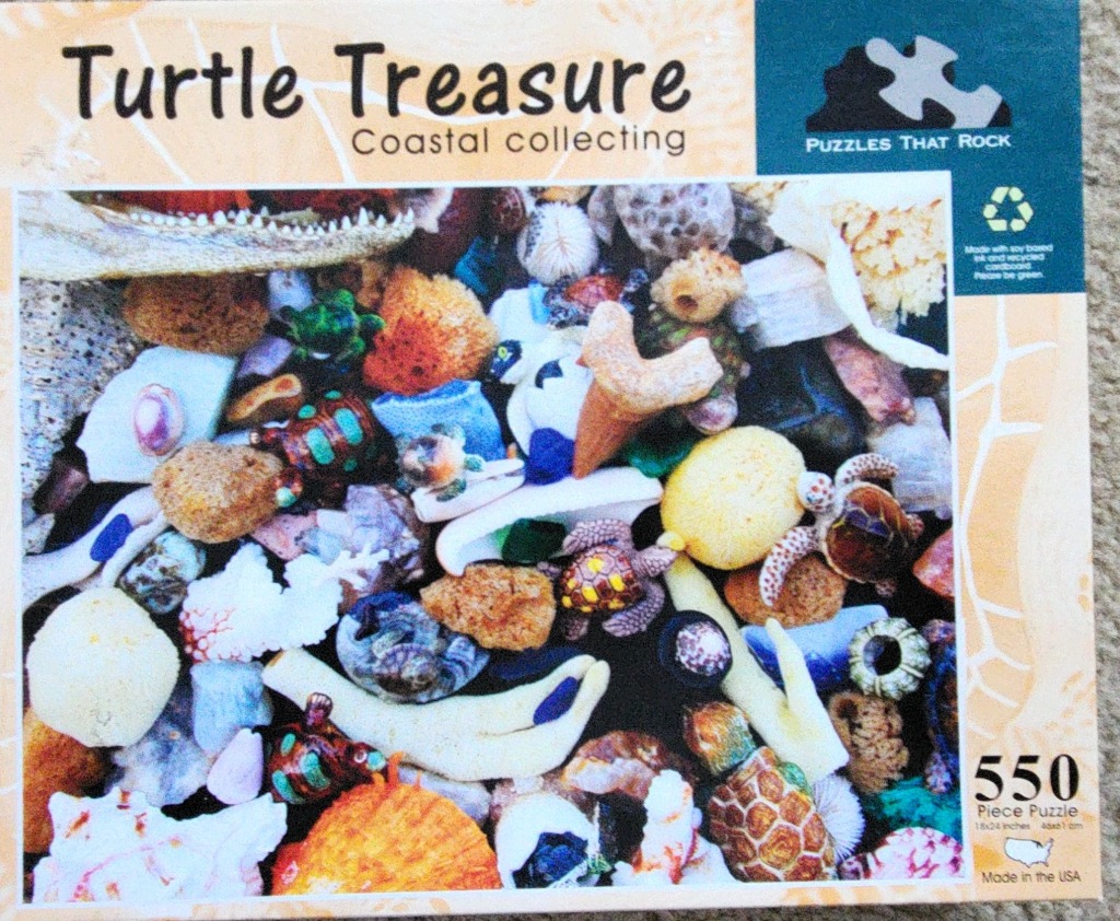 A collection of sea glass, shells, coral, and small decorative turtle figurines.