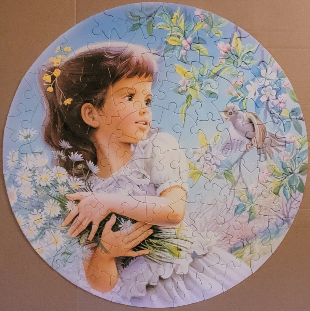 A circular illustration of a young girl with brown hair holding a large bouquet of daisies while a bird perches nearby.