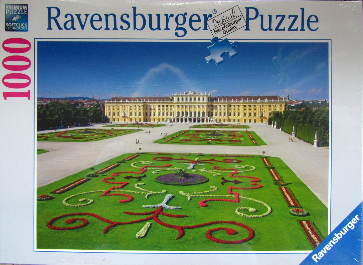 A panoramic view of the yellow Schonbrunn Palace in Vienna with its meticulously manicured baroque gardens.