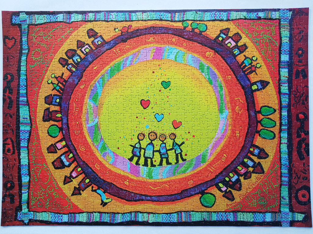 A whimsical illustration of four stick figures holding hands inside a circle surrounded by houses and colorful borders.