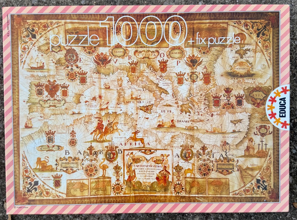 Vintage-style antique map of the Mediterranean region featuring heraldic crests, nautical illustrations, and ornate text.