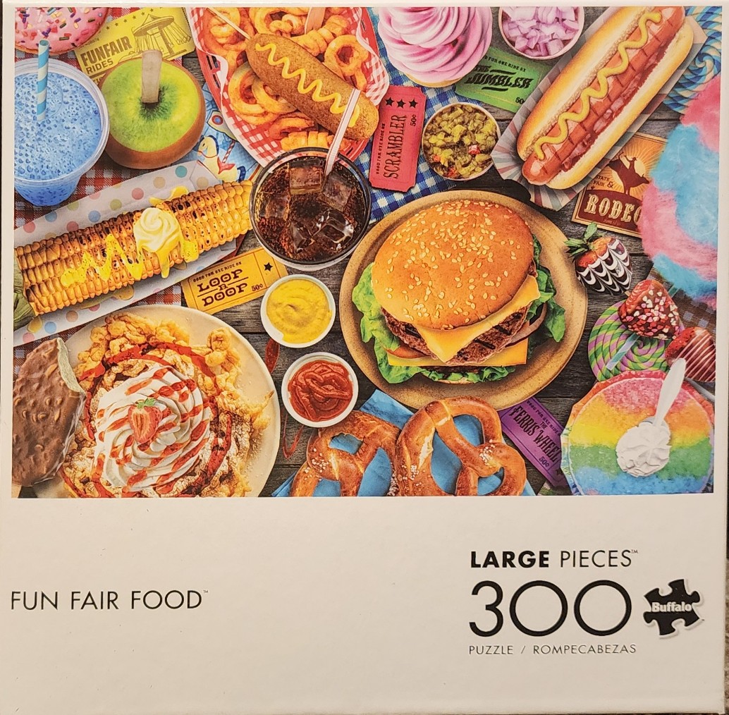 A top-down view of various fairground foods like a burger, hot dog, corn on the cob, and funnel cake.