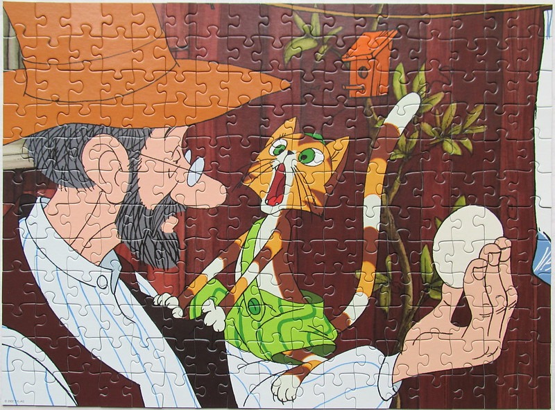 A cartoon illustration of a bearded man in a hat interacting with a surprised-looking orange cat holding an egg.