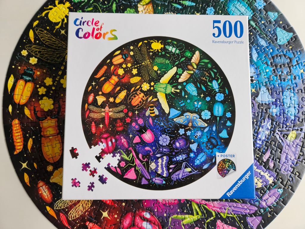 A circular arrangement of colorful insects against a dark background, displayed on a square box.