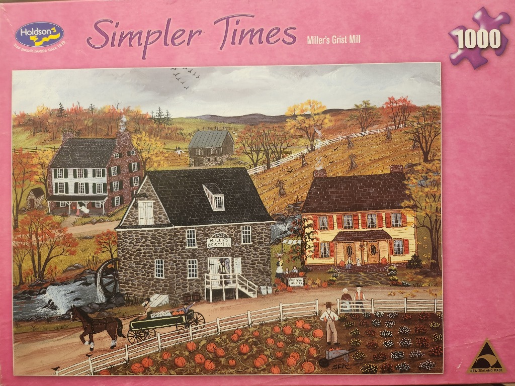 A folk-art style autumn scene of a stone grist mill, farmhouses, a horse-drawn wagon, and a pumpkin patch.