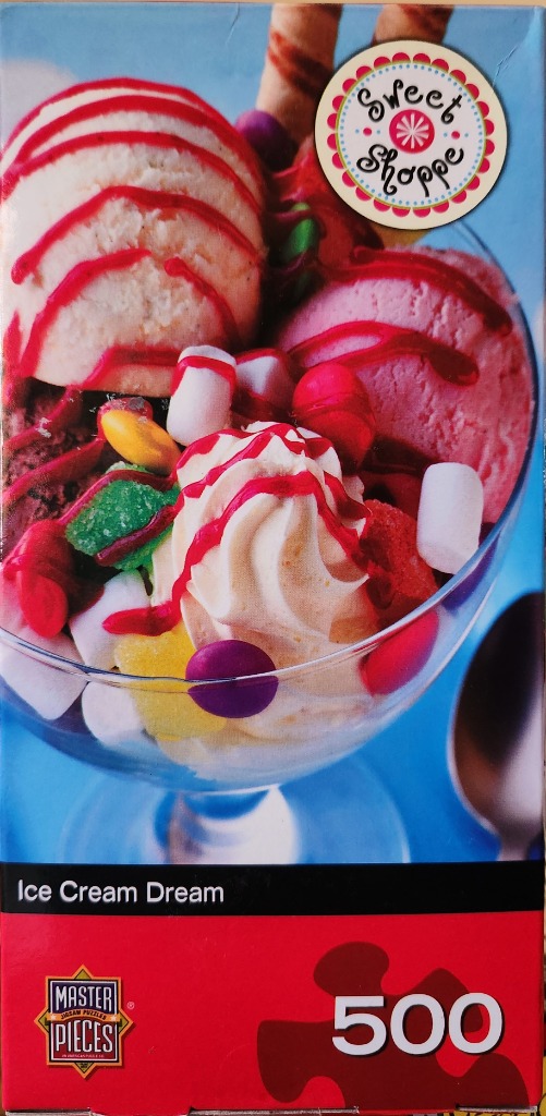 A glass sundae dish filled with scoops of ice cream, marshmallows, candies, and syrup against a bright blue background.