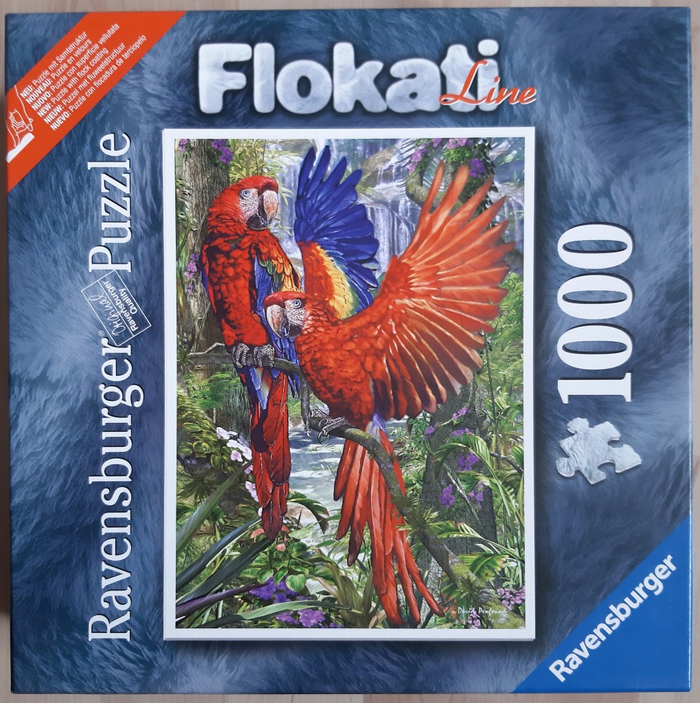 Two vibrant scarlet macaws perched in a lush tropical jungle with a waterfall background.