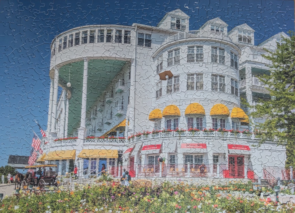 The Hotel del Coronado exterior featuring white Victorian architecture, yellow awnings, and a horse-drawn carriage.