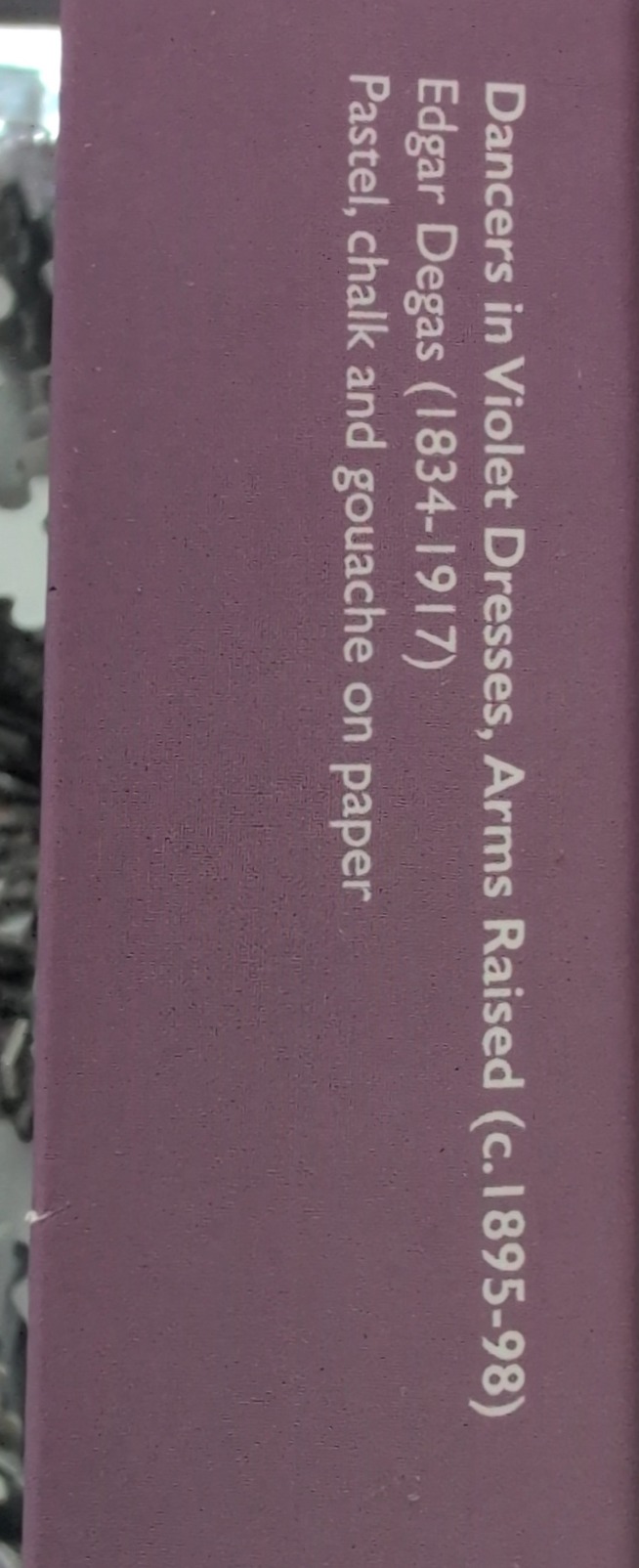 Text on a mauve background identifying the Edgar Degas artwork, Dancers in Violet Dresses, Arms Raised.