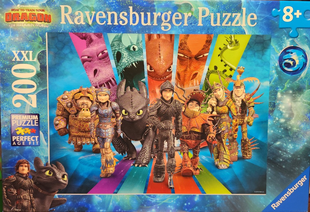 Group of human and dragon characters from How to Train Your Dragon standing against a colorful, abstract background.