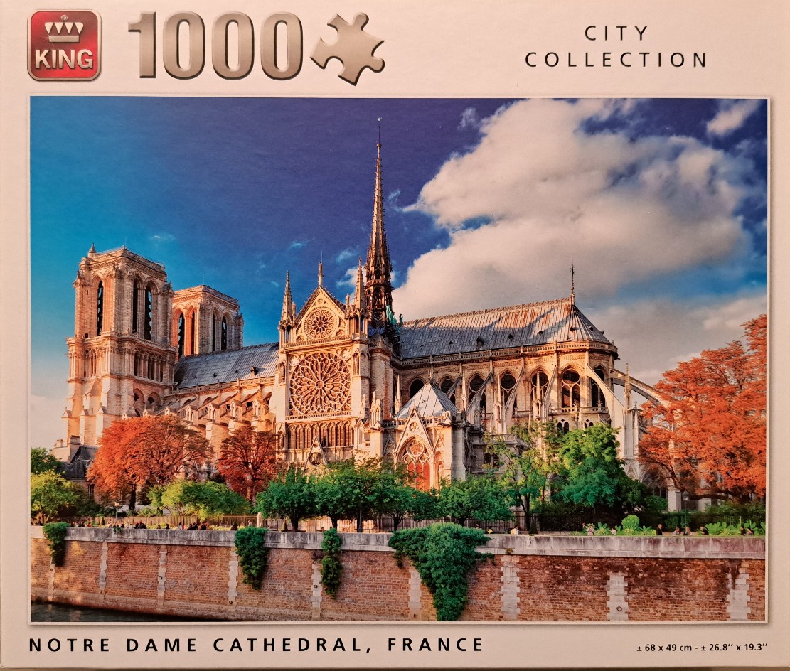 A scenic photograph of the Notre Dame Cathedral in Paris, France, during sunset.