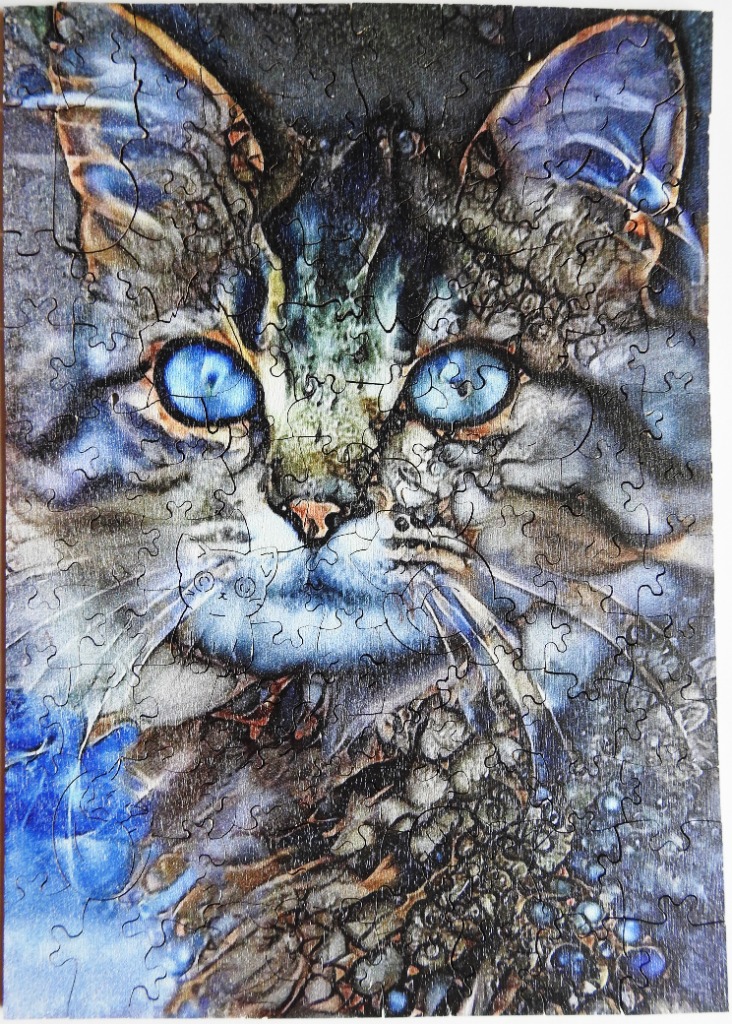 Artistic close-up portrait of a cat with bright blue eyes and textured, dreamlike fur patterns.