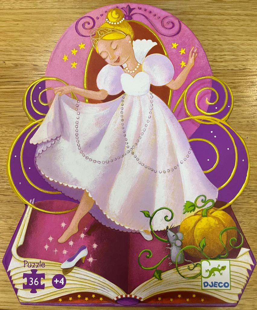 Illustration of Cinderella in a ballgown dancing atop an open storybook with a pumpkin and mouse nearby.