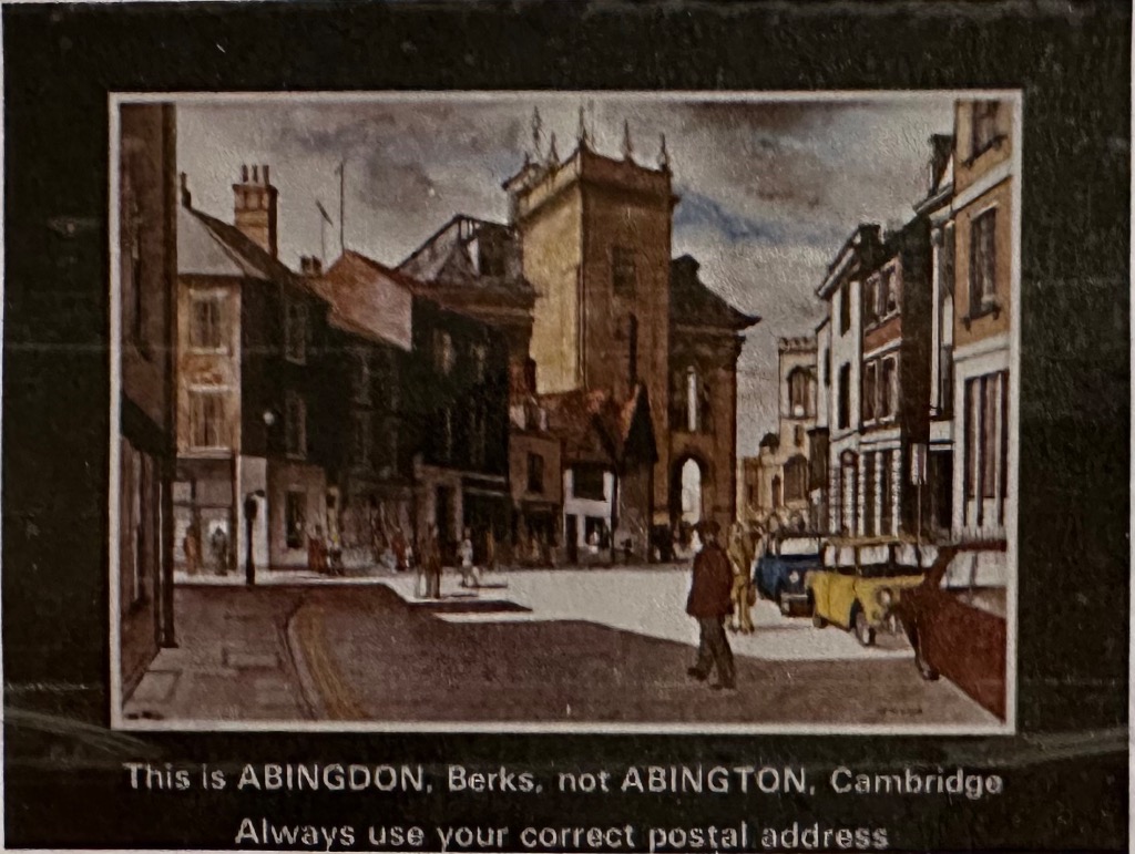 An illustration of a historic street scene in Abingdon with traditional buildings and cars.