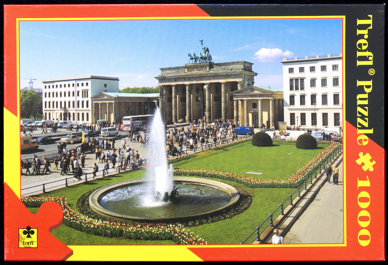 The Brandenburg Gate in Berlin with a central fountain and tulip beds in the foreground