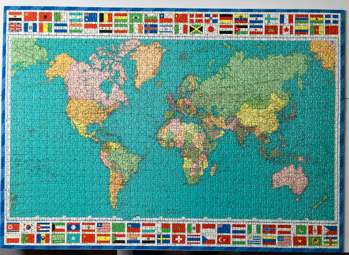 A vintage-style political world map surrounded by a border of colorful international national flags.