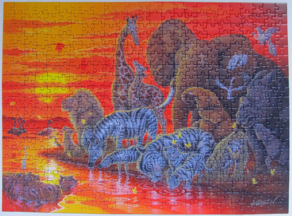 Vibrant African savanna sunset featuring silhouettes of various wild animals gathering at a watering hole.