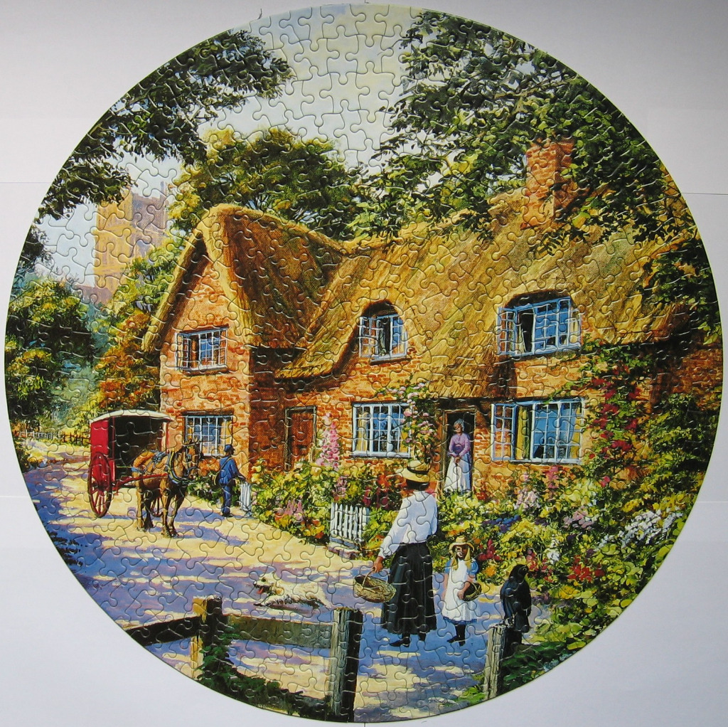 A round illustration of an English thatched-roof cottage with a horse-drawn carriage in front.