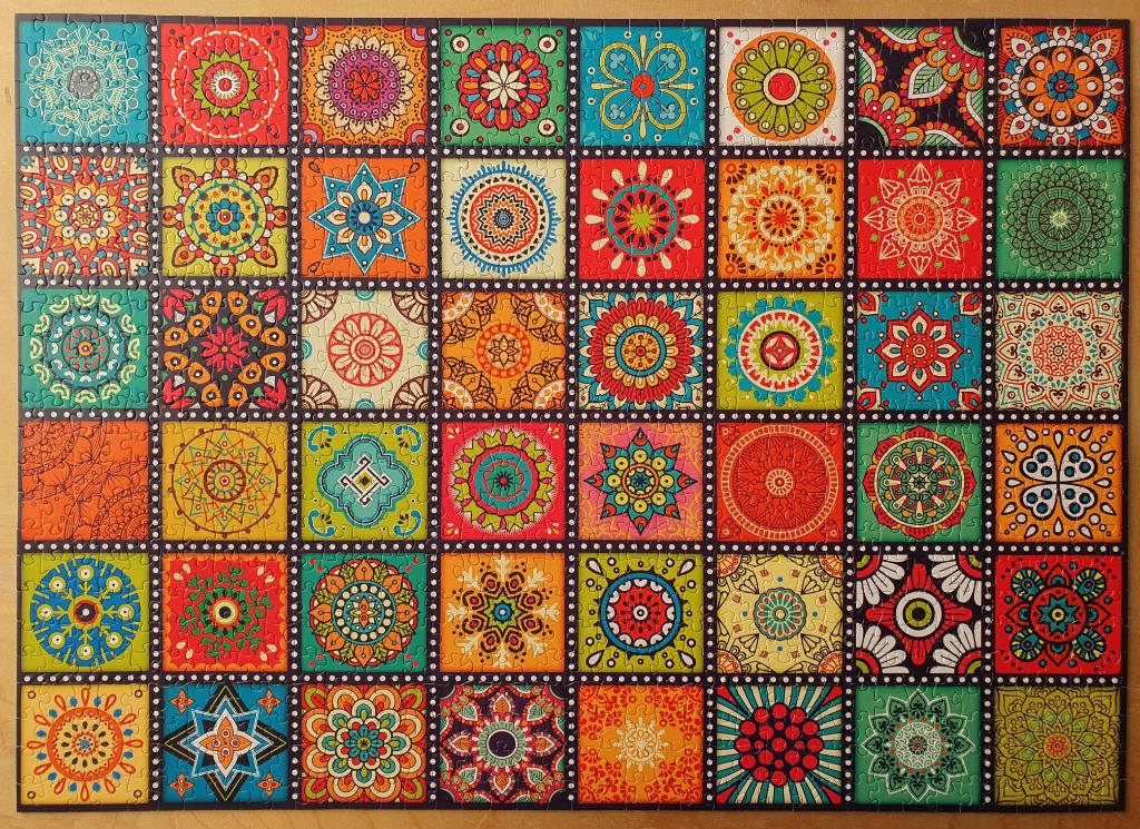 A grid of colorful, diverse mandala-style patterned tiles with intricate floral and geometric designs.