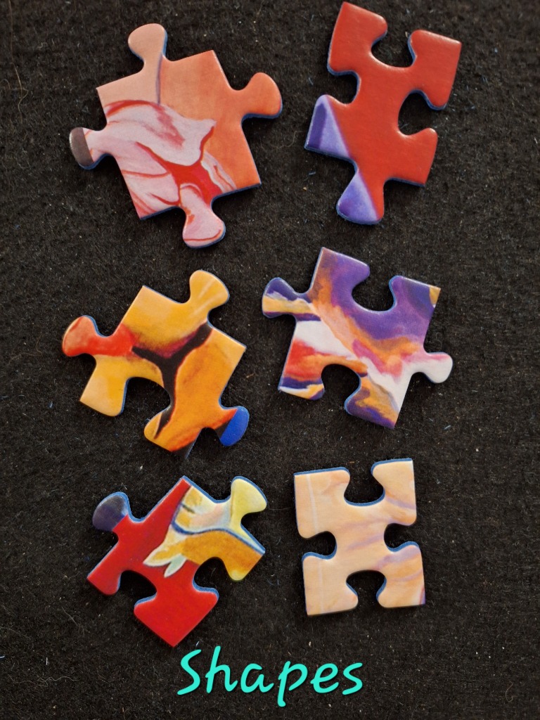 Colorful abstract art jigsaw pieces with organic flow patterns.