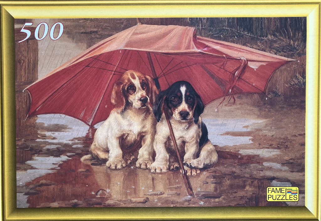 Two small puppies sitting together under a large red umbrella in the rain.