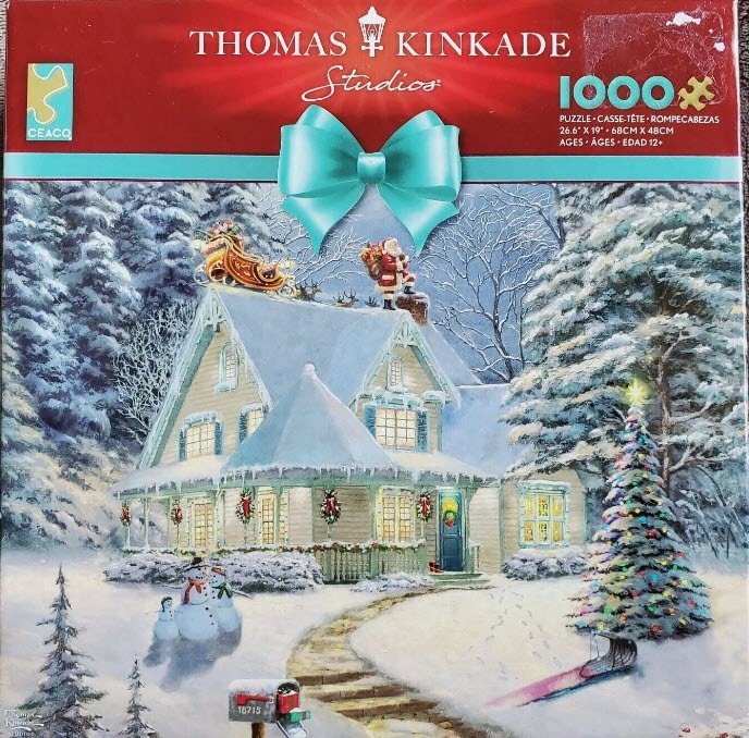 An illustration of a snowy cottage decorated for Christmas with Santa Claus on the roof and snowmen in the front yard.