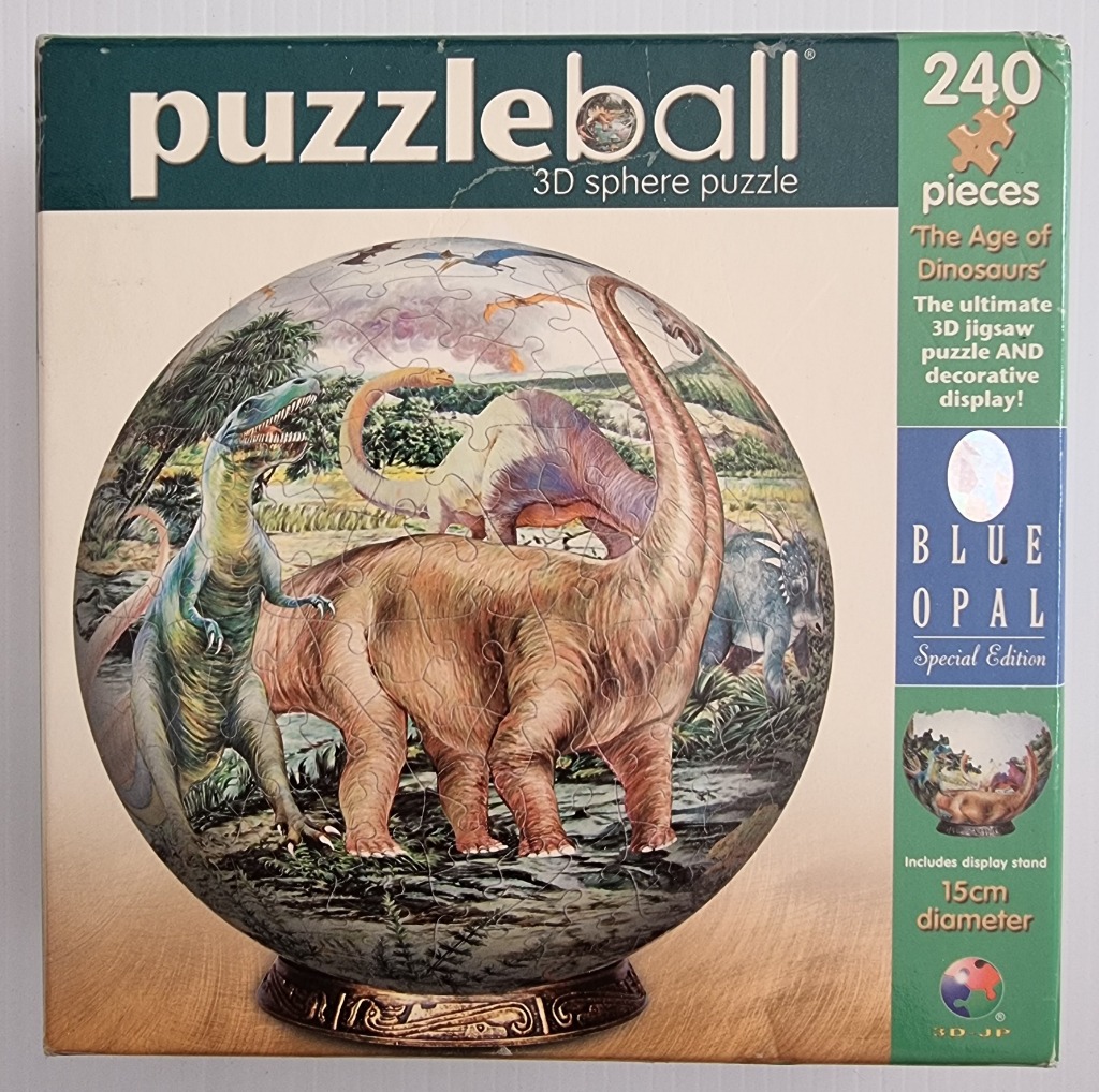 A spherical jigsaw puzzle featuring a prehistoric landscape with various dinosaurs.