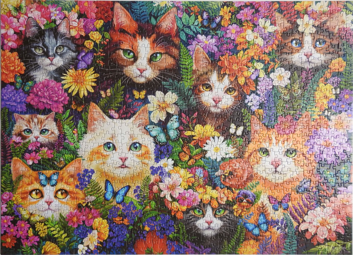 A vibrant illustration of many cats nestled among lush, colourful flowers and butterflies.