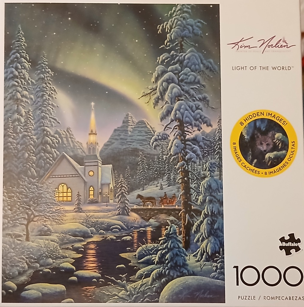 A snow-covered church beside a stream under a green aurora borealis.