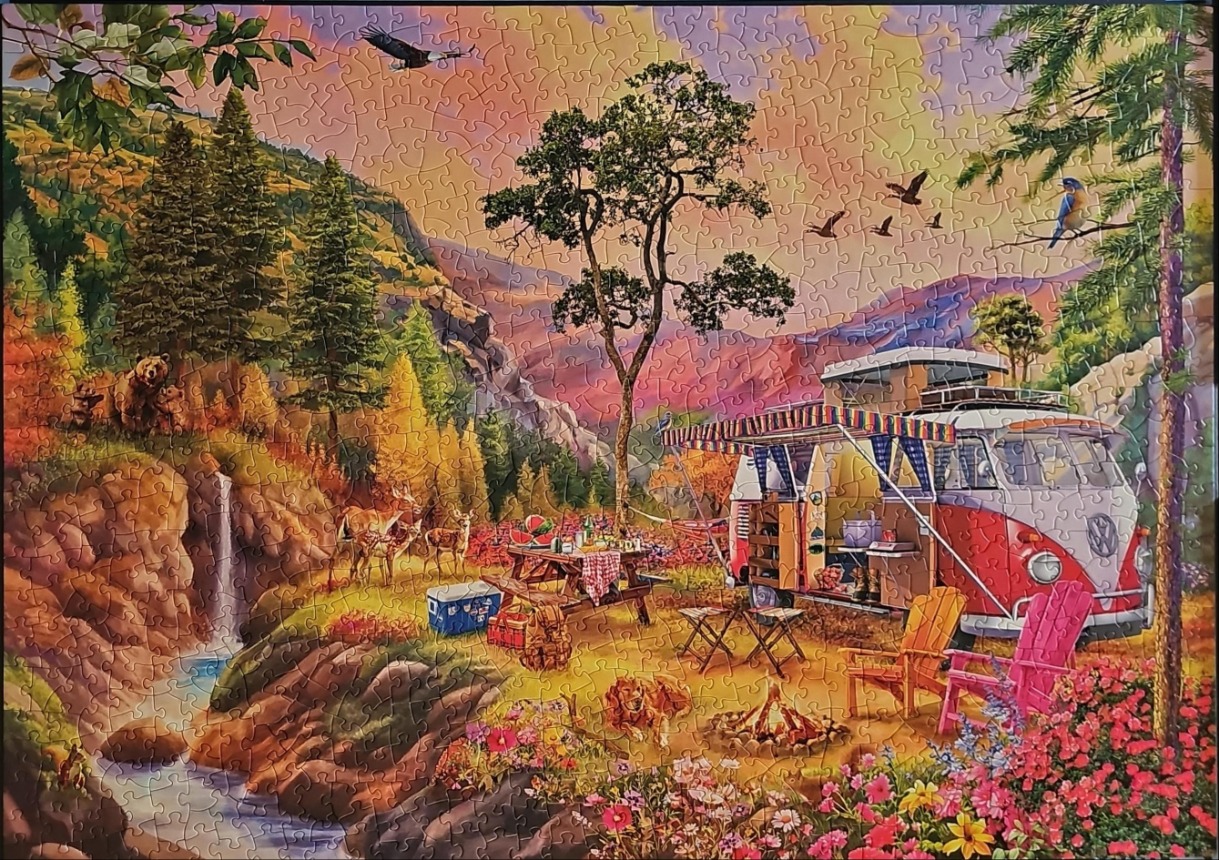 A vintage camper van parked by a waterfall in a vibrant forest at sunset.