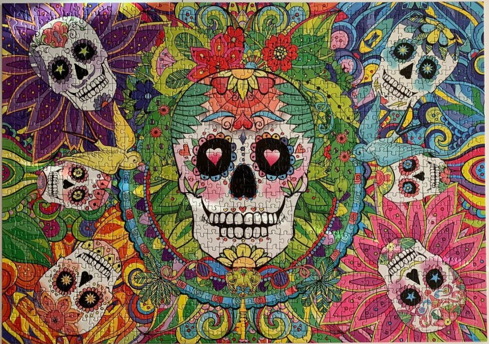 Colorful Day of the Dead illustration with a central skull surrounded by smaller skulls and vibrant floral patterns.