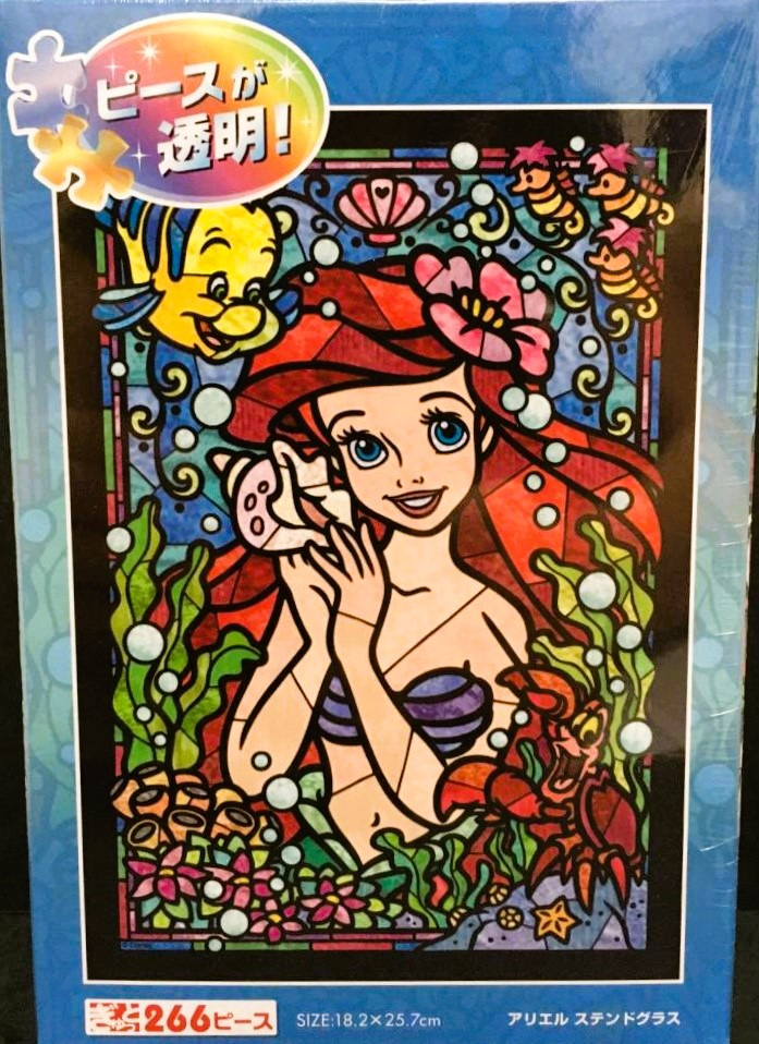 Stained glass style illustration of Ariel from The Little Mermaid surrounded by sea creatures.
