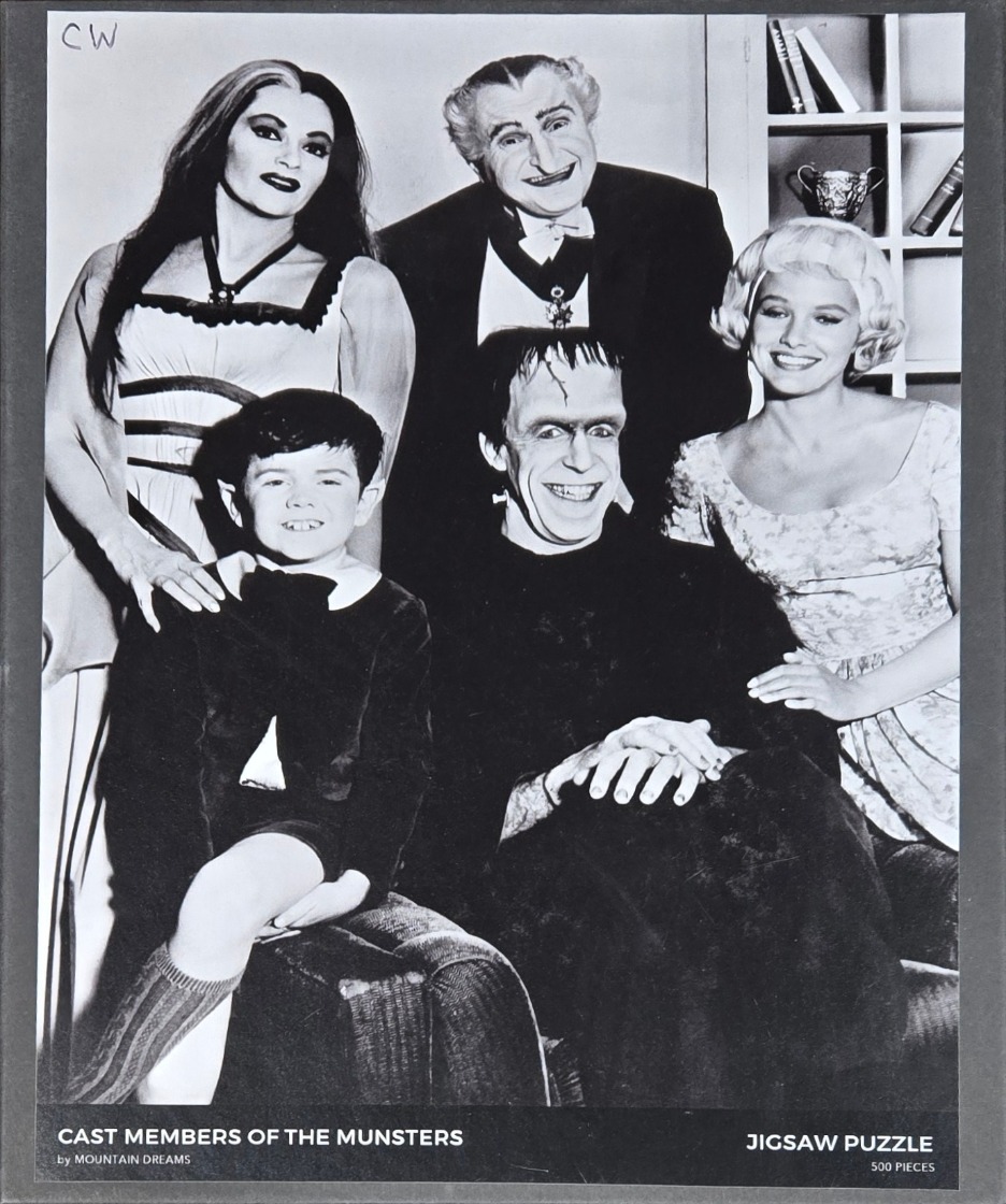 A black and white studio portrait of the main cast of the television show The Munsters.