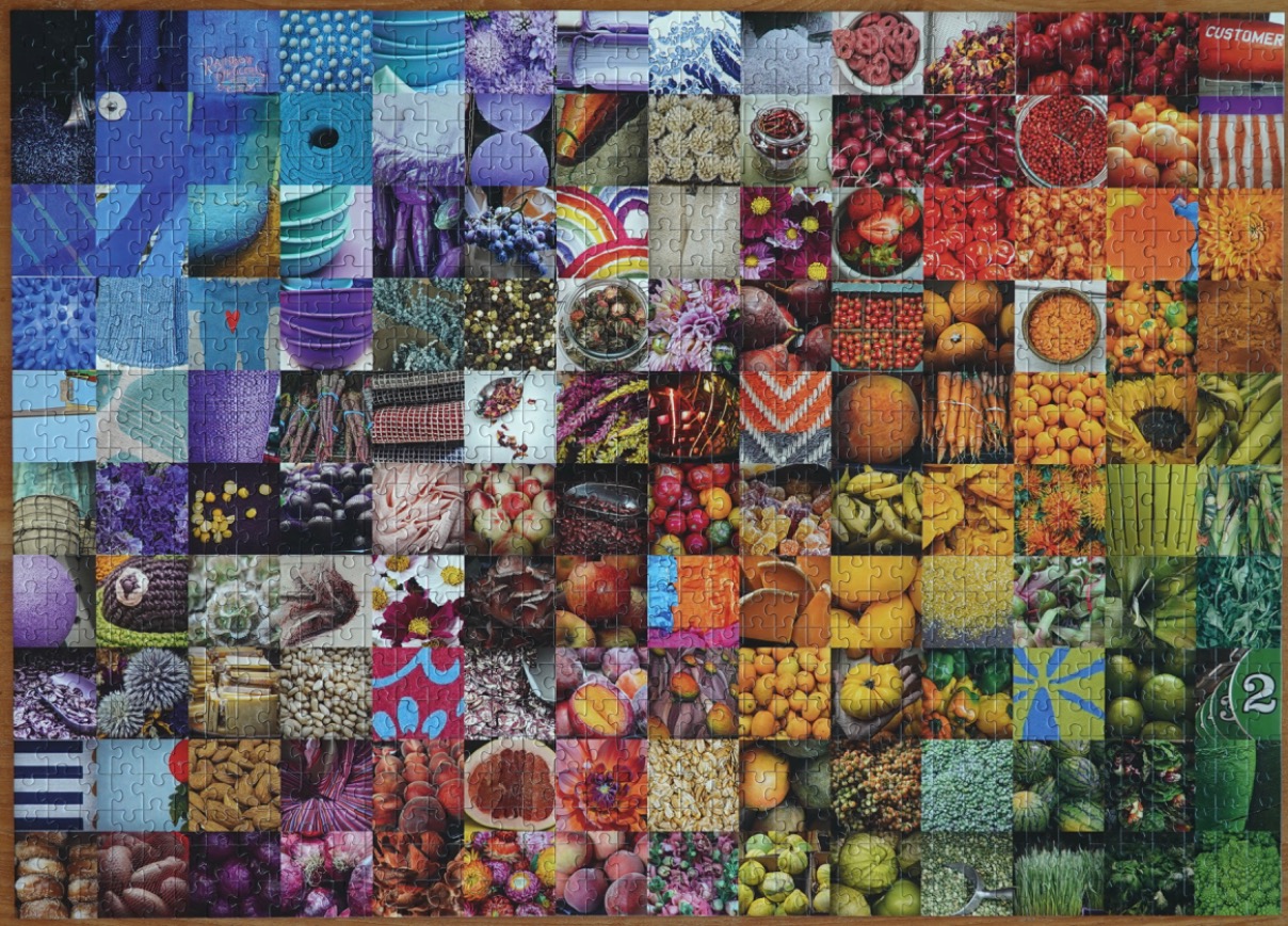A vibrant collage of square photographs arranged in a grid, transitioning through a full spectrum of colors.