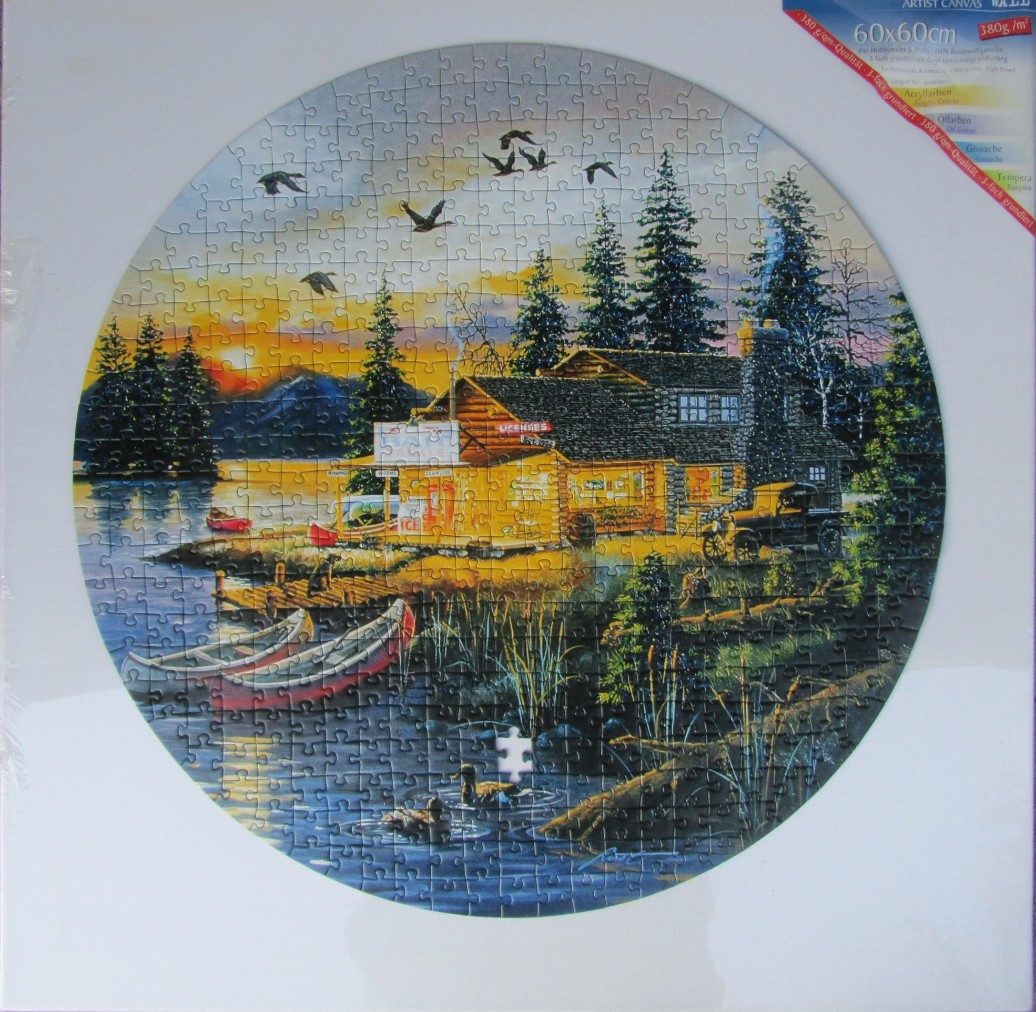 A circular landscape painting of a rustic lakeside general store at sunset with canoes, a vintage car, and flying geese.