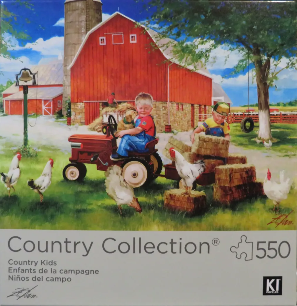 Two young children playing with hay and a tractor on a farm with a red barn in the background.
