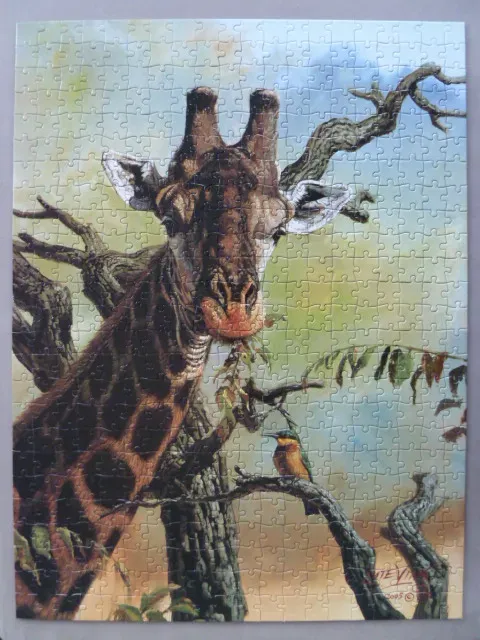 A giraffe stands next to a gnarled tree while a small bird perches on a branch in the foreground.
