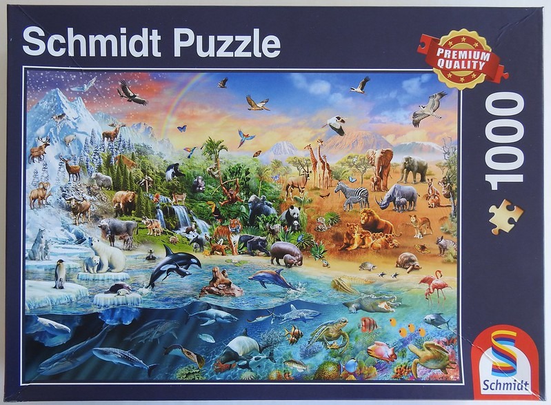 An expansive illustration showing a diverse array of animals transitioning from an arctic landscape to a jungle and ocean.