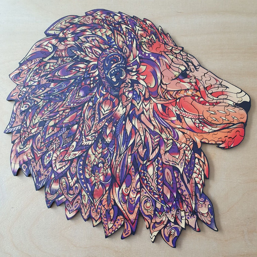 Stylized illustration of a lion's head in profile decorated with intricate patterns in shades of purple, orange, and gold.